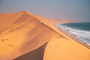 Surreal natural landscape of desert and sea. The topography of the Atlantic coast of Africa. Areas with scarce water resources. Popular travel destination in Namibia.
