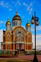 Fototapeta na wymiar The modern Cathedral of Intercession of the Mother of God, in the Obolon district of Kiev, Ukraine, near the Dnieper river, on sunny day