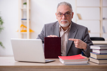 Aged male teacher in the classroom