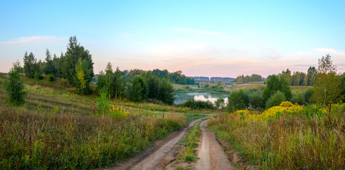Fototapeta na wymiar Summer morning landscape with calm lake