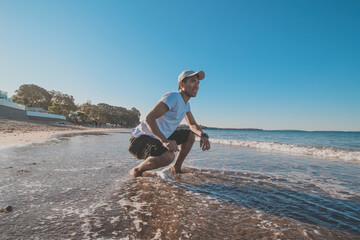 
Asian man taking a photo shoot at campbells bay beach, Auckland, New Zealand