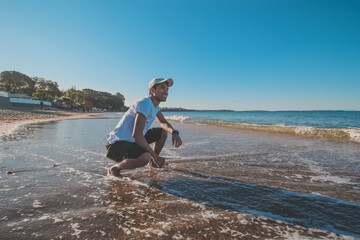 
Asian man taking a photo shoot at campbells bay beach, Auckland, New Zealand