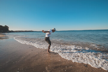 
Asian man taking a photo shoot at campbells bay beach, Auckland, New Zealand
