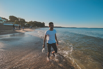 
Asian man taking a photo shoot at campbells bay beach, Auckland, New Zealand