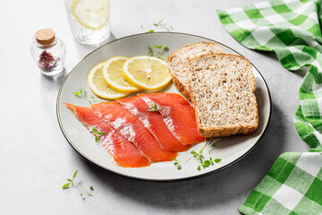 Salted salmon slices for healthy breakfast sandwiches. Organic fish. Light gray background.	