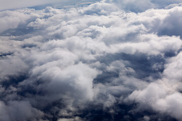 Flying above cumulus clouds . Dramatic cloudscape 