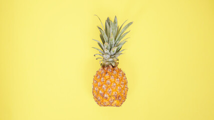 a pineapple isolated on yellow background