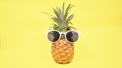 pineapple in glasses isolated on a yellow background
