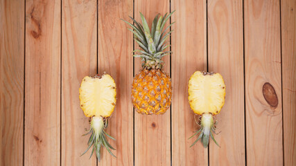 pineapple fruit and its pieces on a wooden background