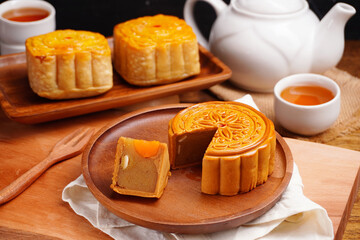Obraz na płótnie Canvas Mooncakes Stir Fried Durian Filling with Salted Egg Yolk and hot tea Asian Festival