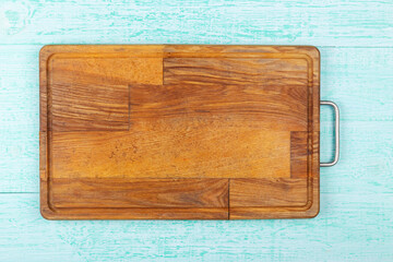 Empty cutting board on a wooden background. Top view.