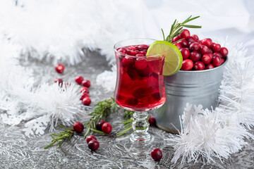 Christmas cranberry drink with berries, lime, and rosemary.
