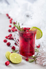 Christmas cranberry drink with berries, lime, and rosemary.