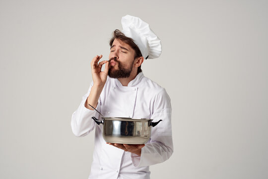 emotional male chef with a saucepan in his hands cooking restaurant industry