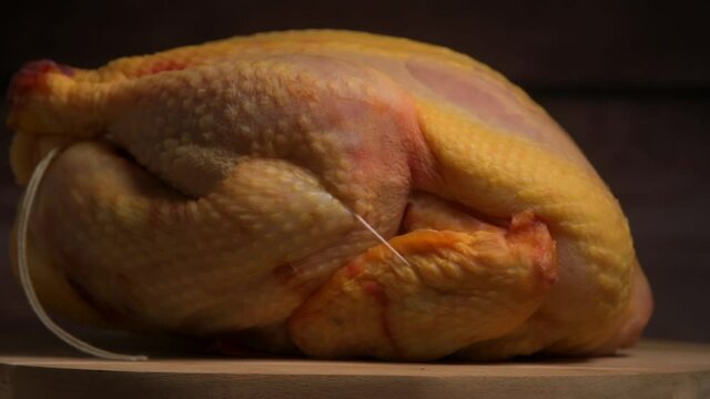 Raw broiler chicken meat on turntable, Fresh diet poultry meat on a brown background, Preparing a meat product, hight quality