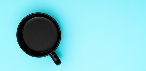 Top view, flat lay of black coffee cup on background blue.