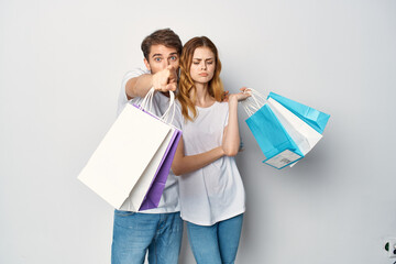 man and woman with packages in hands shopping emotions