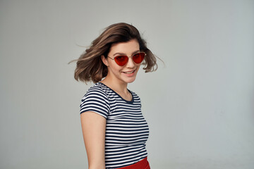 pretty woman in a striped T-shirt posing Studio