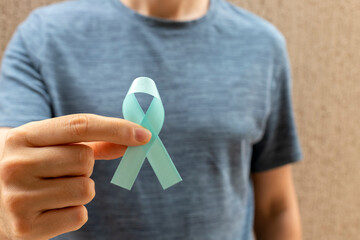 man holding blue ribbon. Men's health. Blue november. Prostate Cancer Prevention Month.