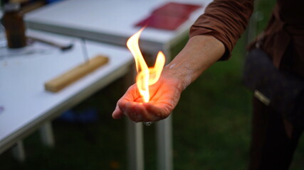 Magic of chemistry flaming hand, lighting and holding a small fire in your hand with butane-filled...