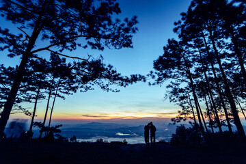 Silhouette couple with a beautifu mountain ridge and sky