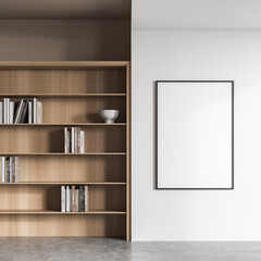 Empty frame on white living room wall with bookcase