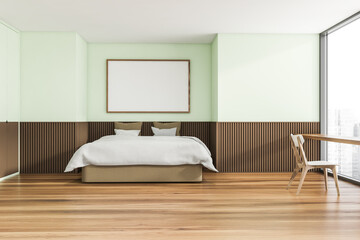 Horizontal canvas on light green wall of trendy bedroom