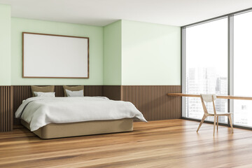 Horizontal canvas on light green wall of trendy bedroom