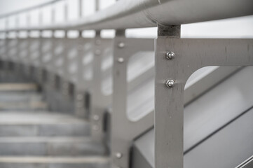 metal frame with bolts.  rhythmic architectural background, going into perspective.  gray lifeless...