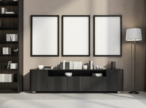 Three frames on beige wall in living room with black wood sideboard