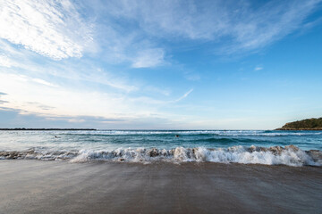 A seashore with crushing waves and beautiful blue sky