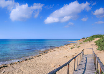 Fototapeta na wymiar The most beautiful beaches of Italy: Campomarino dune park in Apulia, Italy. The protected area extends along the entire coast of the town of Maruggio. 