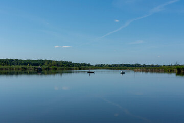 Peaceful lake landscape with blue sky in summer.
