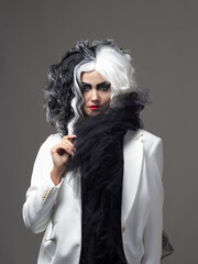 A fatal beauty in a daring fashion image with black and white hair.
