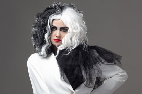 A fatal beauty in a daring fashion image with black and white hair.