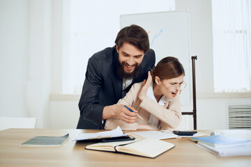 Fototapeta premium business man and woman sitting at the table working office officials