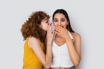 Close up photo of two womans who gossiping on white background