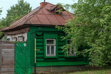 The beautiful old windows with beautifully designed platbands window on an old wooden house in the city of Tula