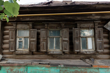 The beautiful old windows with beautifully designed platbands window on an old wooden house in the city of Tula