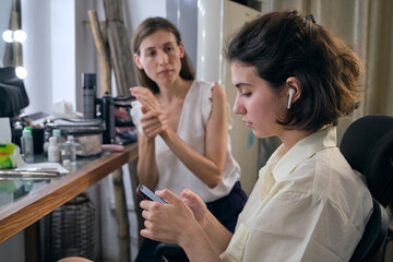 Female professional model at makeup before studio photo shooting