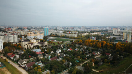 Construction of modern multi-storey buildings. Construction of a new city block. Buildings under construction and tower cranes. Aerial photography in cloudy weather.