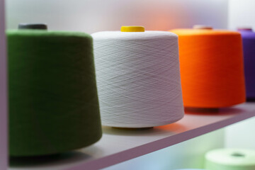 large group of bobbin thread cones on the shelf