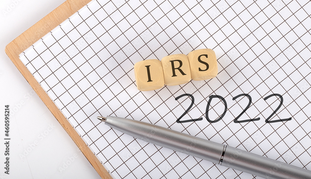 Poster irs 2022 text concept written on the wooden cubes blocks and notebook