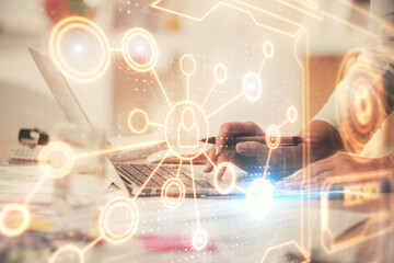 Double exposure of woman hands typing on computer and social network theme hologram drawing. People...