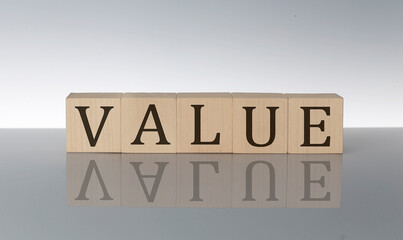 VALUE concept, wooden word block on the grey background