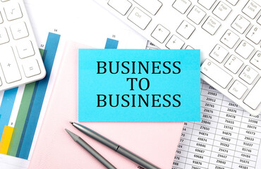 BUSINESS TO BUSINESS text on blue sticker on chart with calculator and keyboard,Business concept