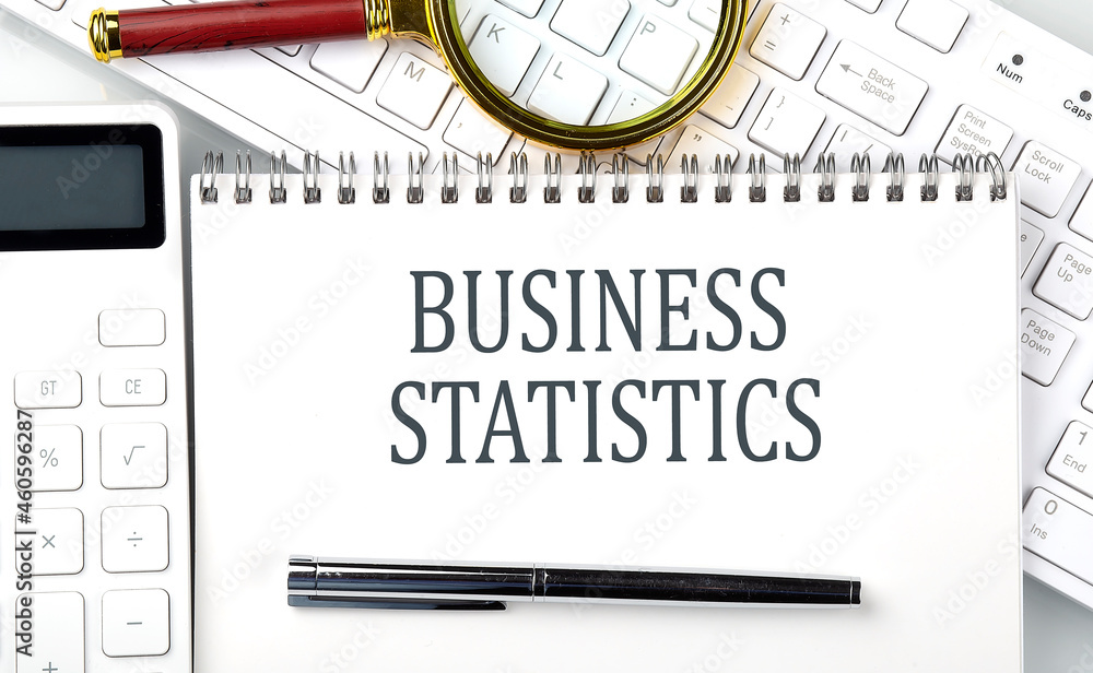 Poster business statistics . text on notepad with calculator and keyboard,business concept