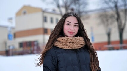 Portrait of a young girl in the winter in the city.