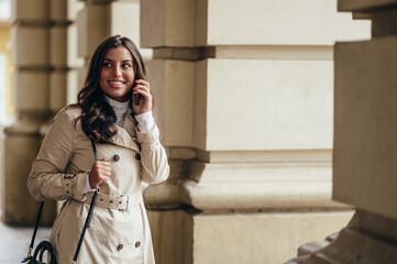 Beautiful young woman using a smartphone while out in the city