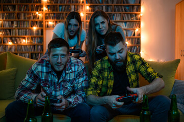 A group of friends playing video games at home while having fun